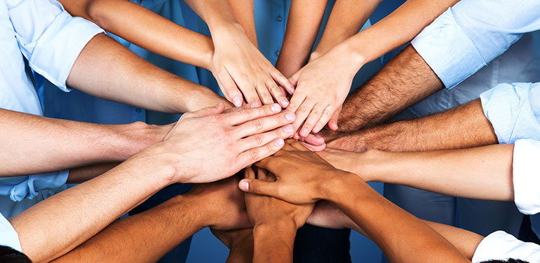 Group of hands in the middle of a circle