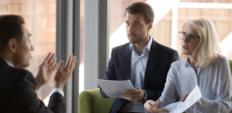 Three people in serious discussion