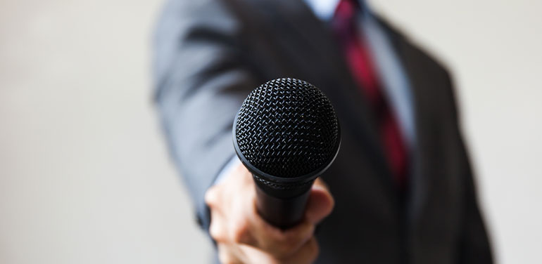 Man holding out a microphone