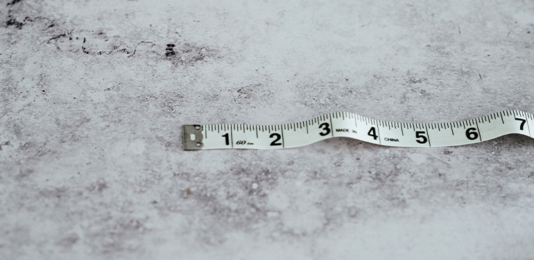 Tape measure on a grey background