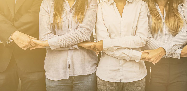 people standing in a line holding hands