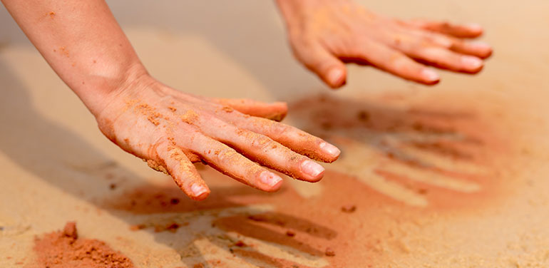 hands in red earth