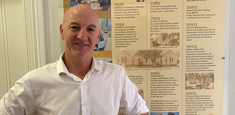 Man standing in front of poster