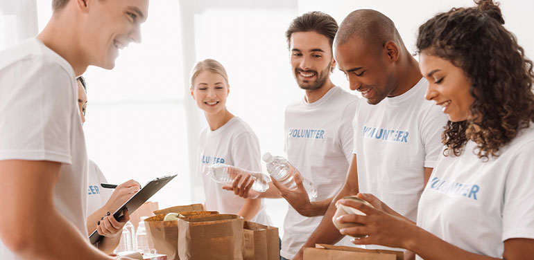 Volunteers packing food in bags