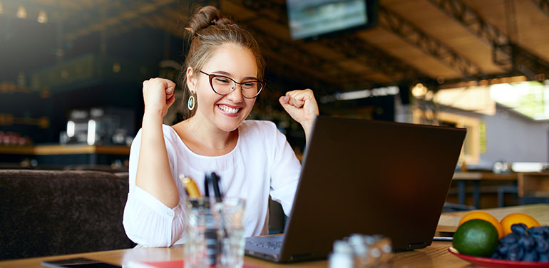 Happy woman looking at her laptop.