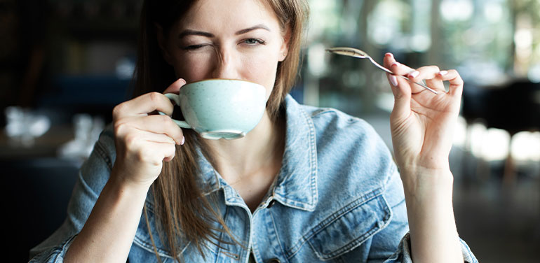 Woman drinking cup of coffee