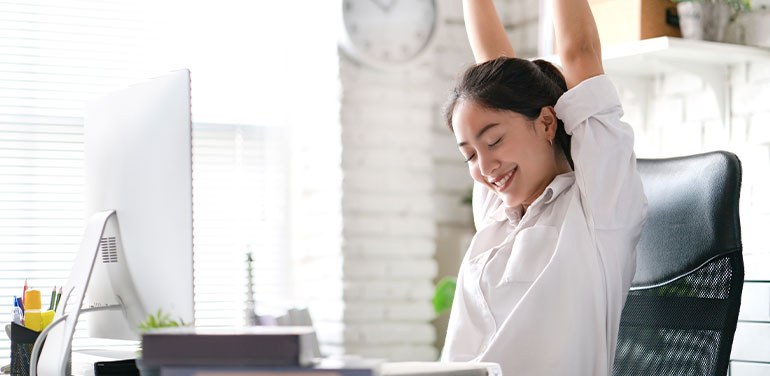 woman stretching at her desk