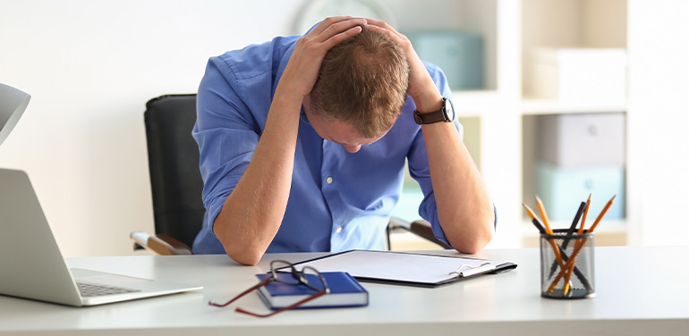 Man having panic attack at workplace in office