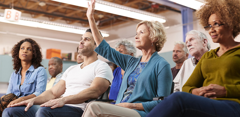 Woman asking question at community meeting