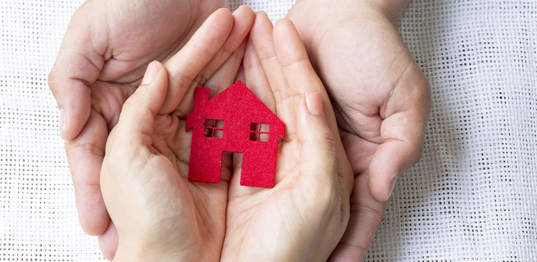 hands holding a house