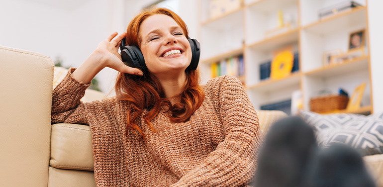 Woman listening to a podcast through earphones