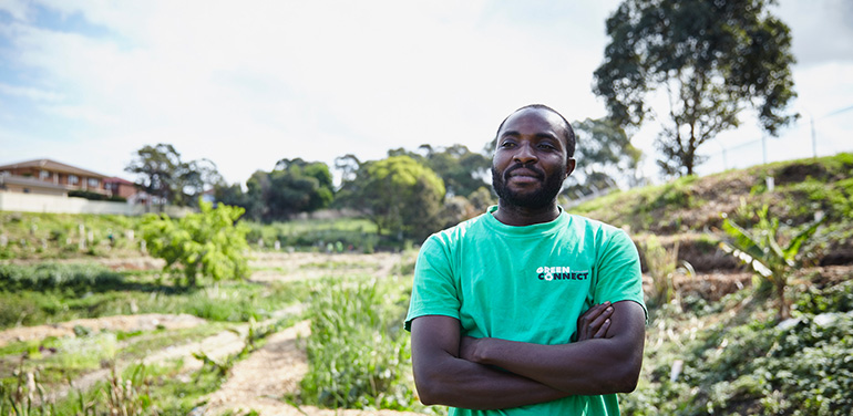 Man standing outside wearing Green Connect tshirt