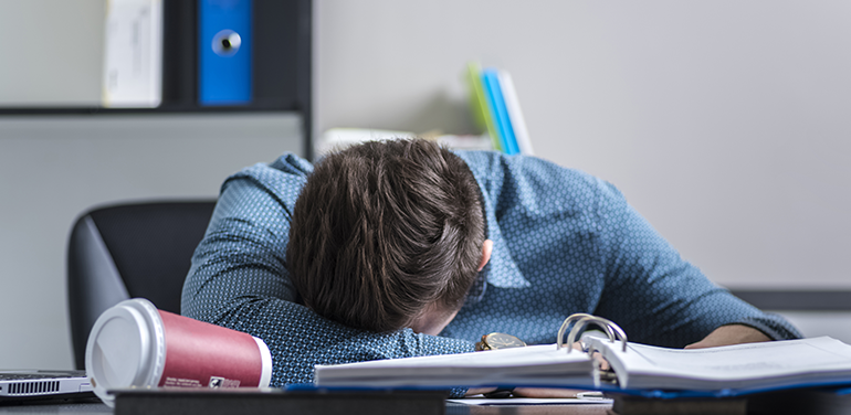 worker asleep on desk