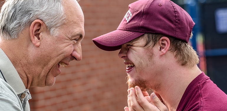 two men laughing together