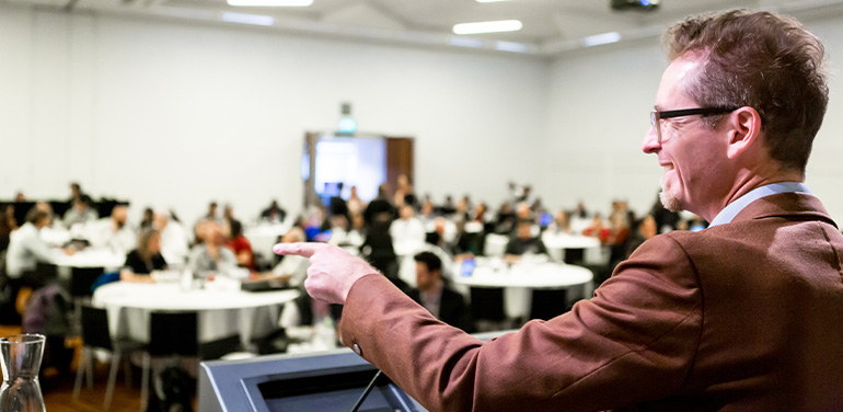 man speaking at the Connecting Up conference in 2019