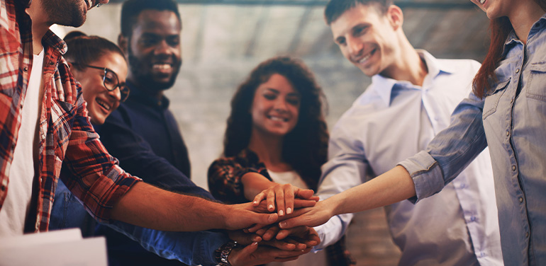 office workers with hands together