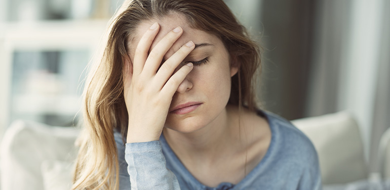 woman looking anxious with her hand over her face