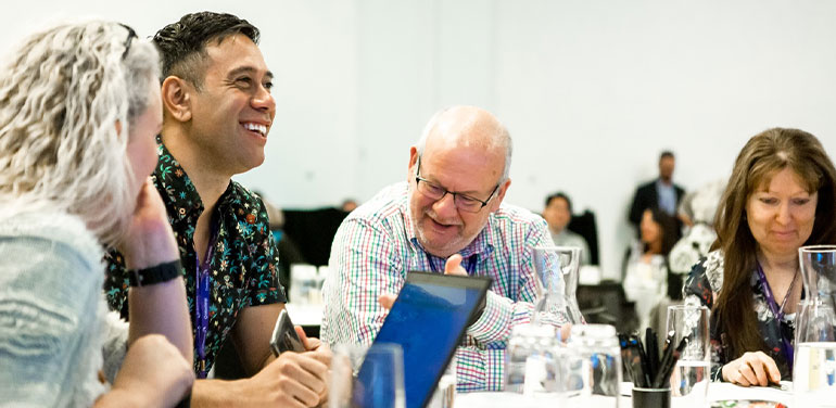 People sitting at a round table at last year's Connecting Up Conference