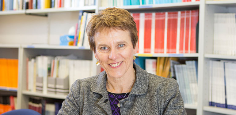 Dr Briony Dow sitting at her desk