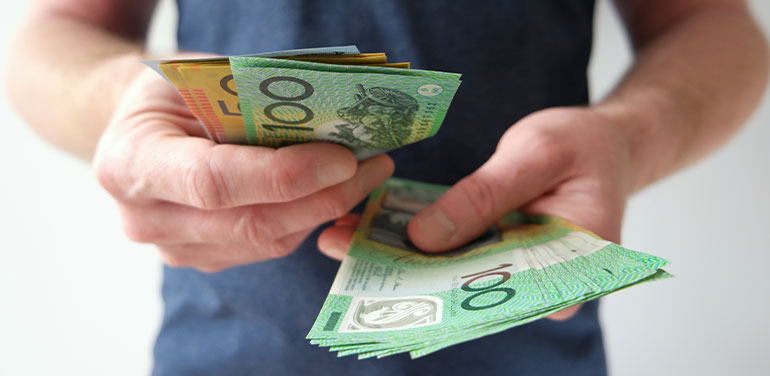 close up of hands holding dollar bills