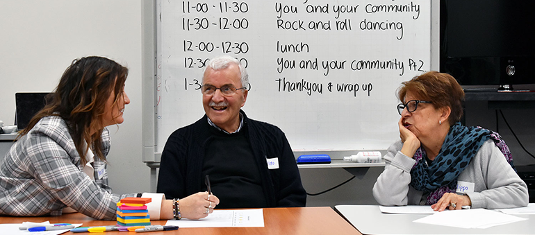 three people sitting at table