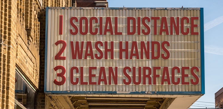 a movie cinema billboard with three basic rules to avoid the coronavirus epidemic of wash hands, maintain social distance and clean surfaces