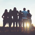 group of friends looking into the sunset