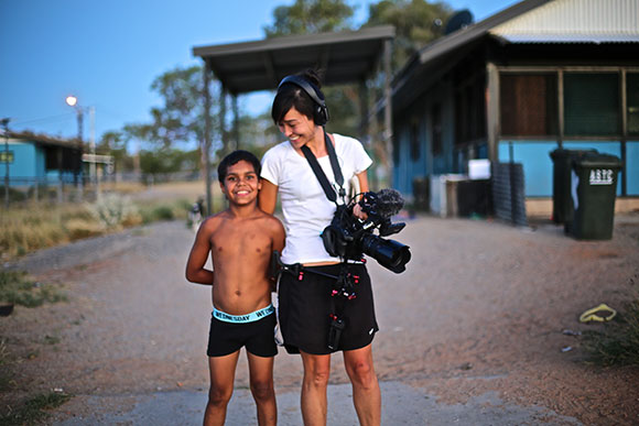 Dujuan standing with director Maya Newell