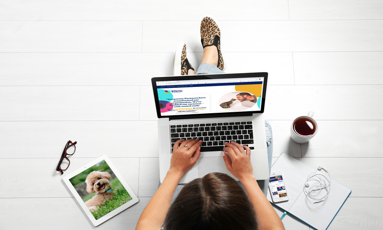 woman sitting on the floor working on her laptop