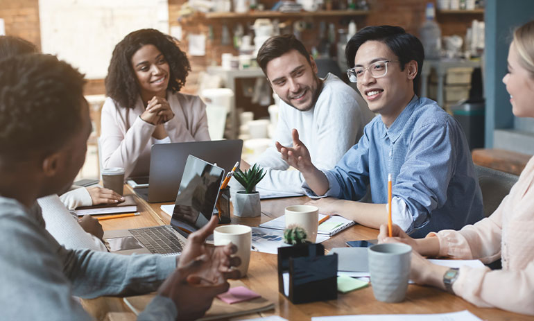 people sat at a table having a meeting