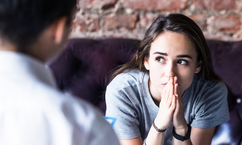 Young woman visiting therapist counselor