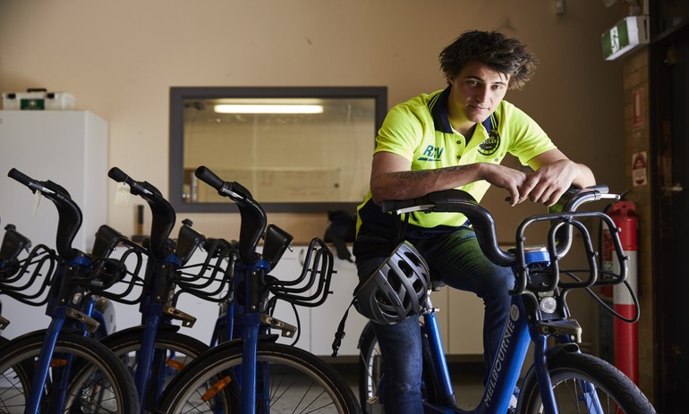 A man sitting on a bike.