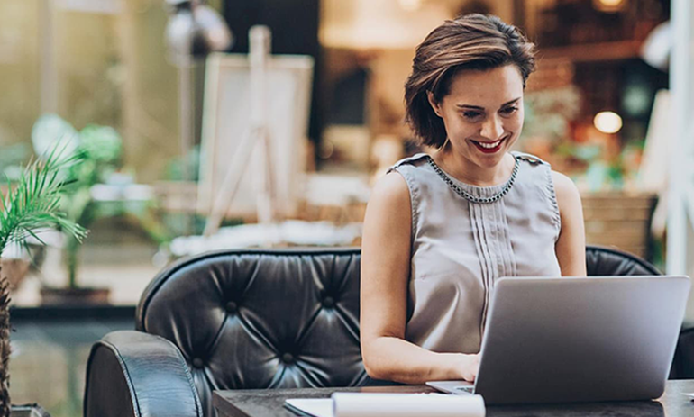 Smiling woman working on her laptop