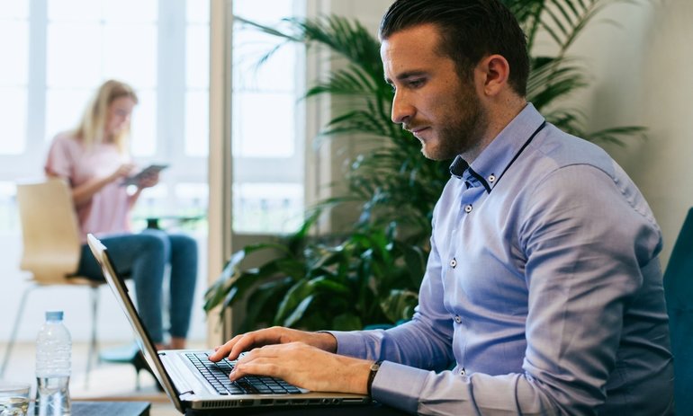 Man typing on a laptop