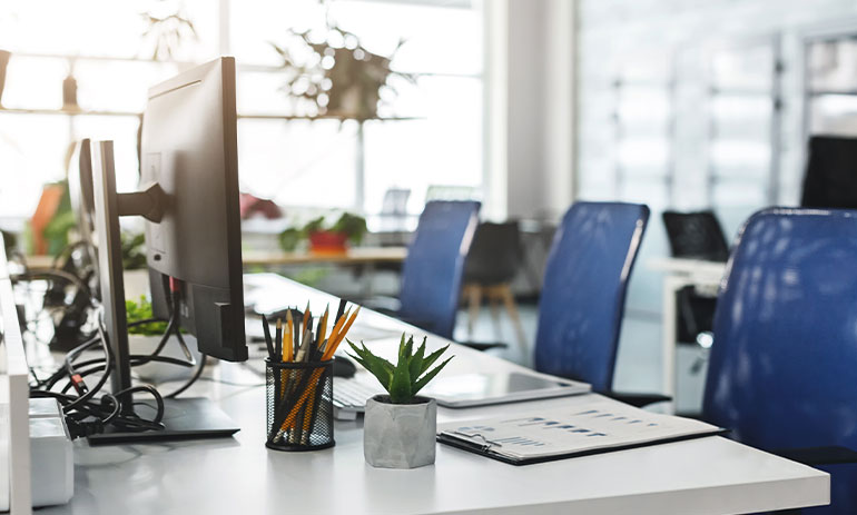 desktop computer on a desk in an empty office