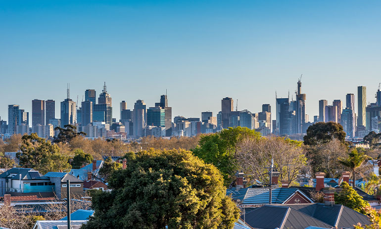 Melbourne skyline with house roofs in the foreground