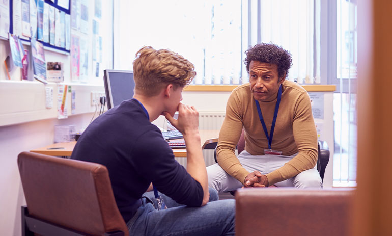 young man speaking with counsellor