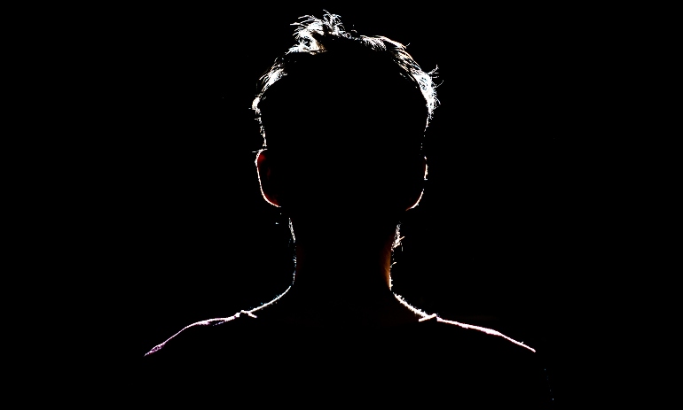 silhouette of man in dark place