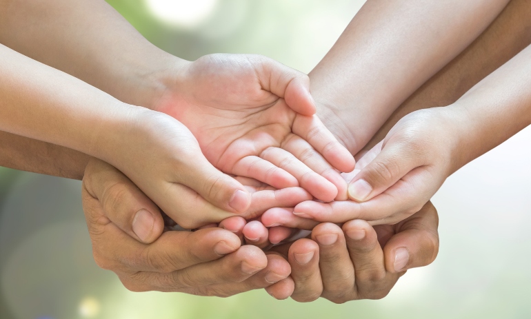 Family praying together for donation for the poor