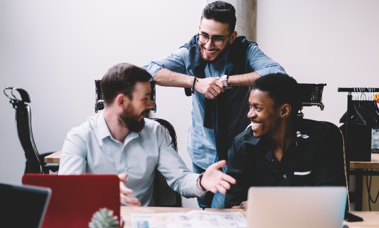 Happy workers sitting at a desk