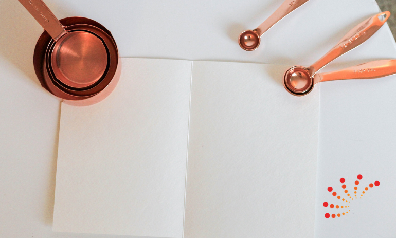 measuring cups and spoons on piece of paper