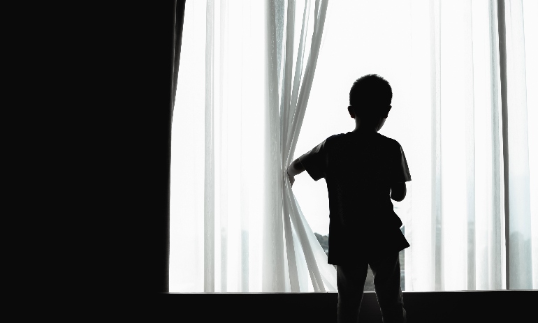 silhouette of kid opening curtain window
