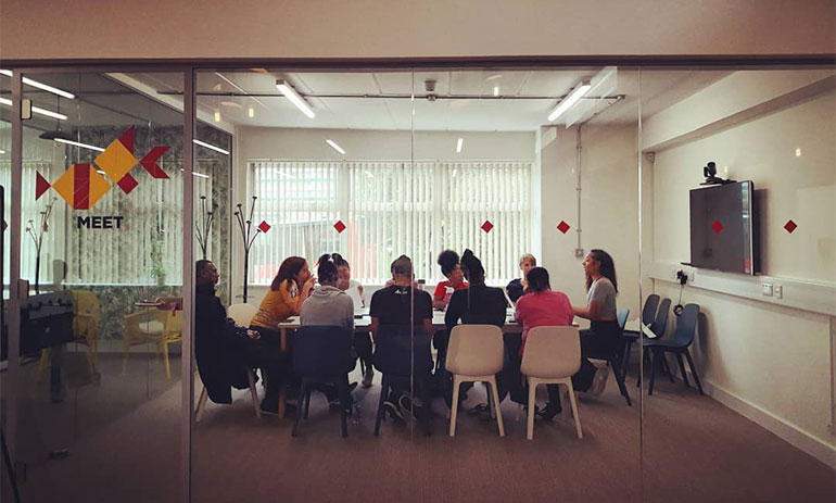 group of people sat around a table at SEIDs meeting