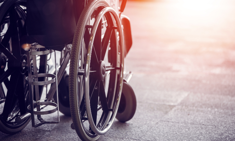 Close-up Empty wheelchair in front of the Outpatient Department of Hospital with sunlight