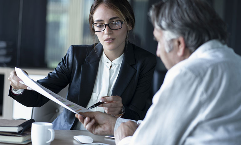 woman showing man document