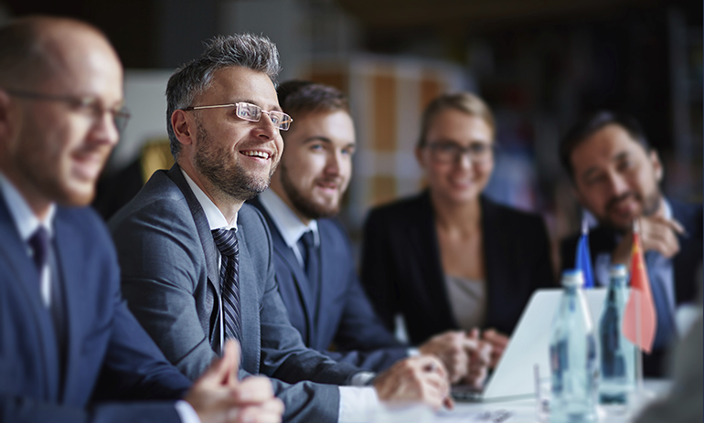 Successful businesspeople sitting at conference or seminar during lecture