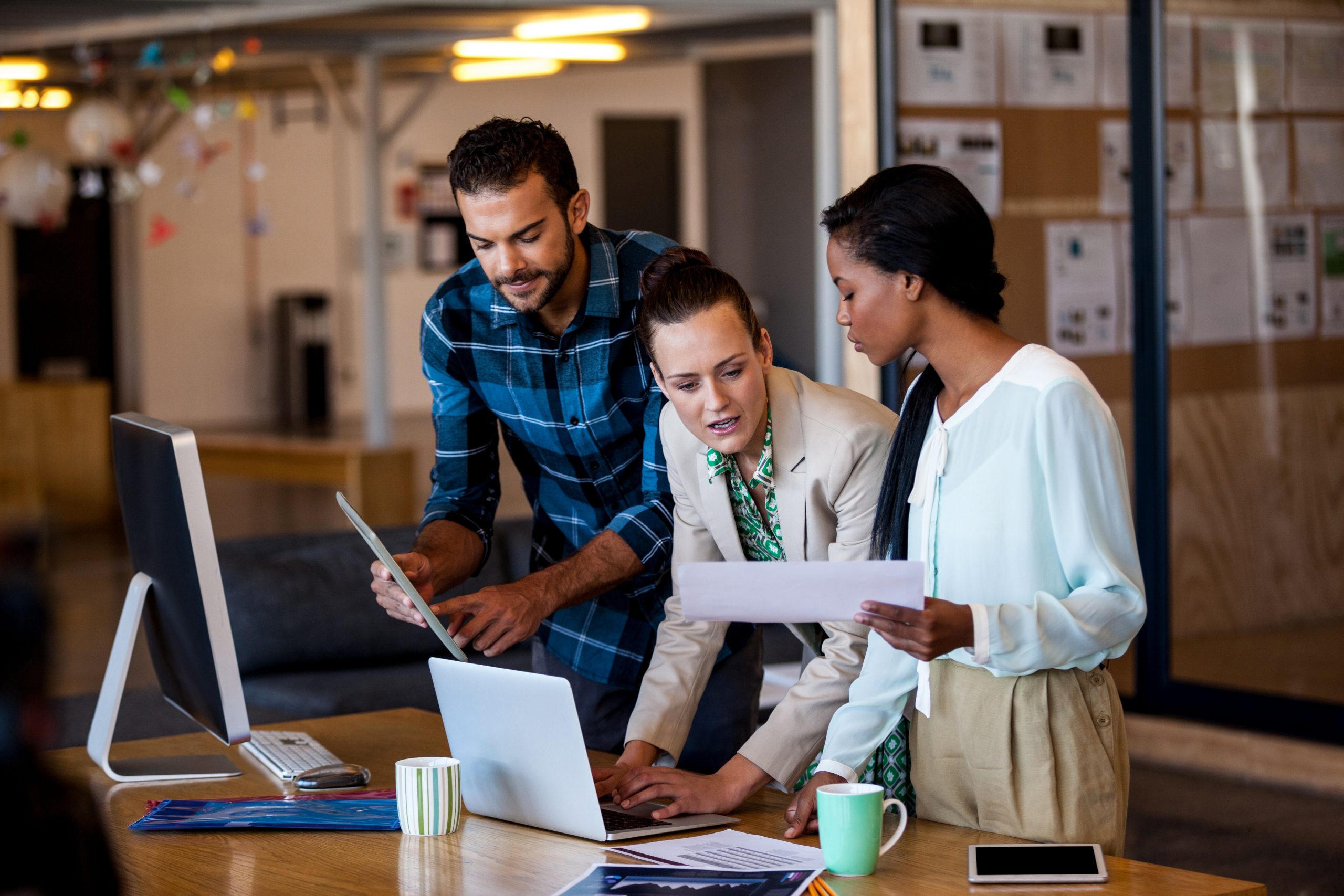 young multi-ethnic business people working at computer desk