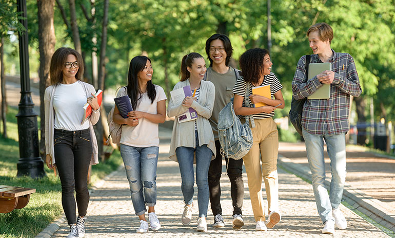 group of university students walking in a line outside