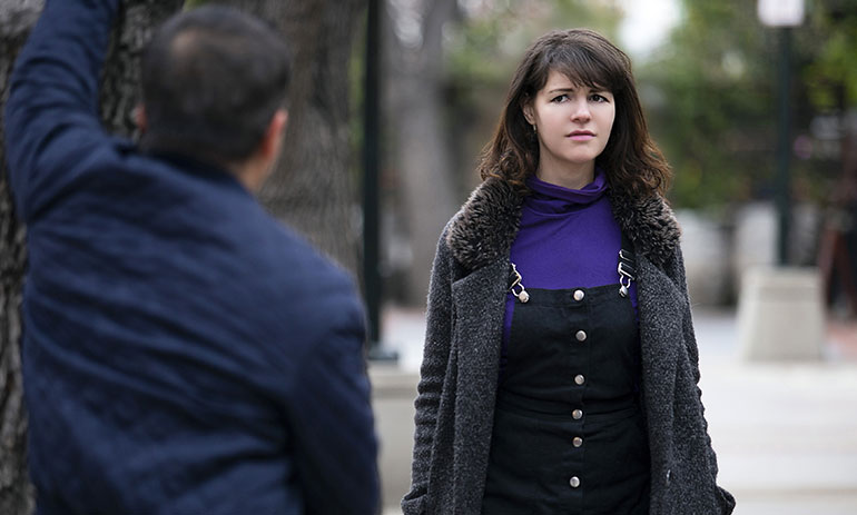 woman looking concerned at a man in the street