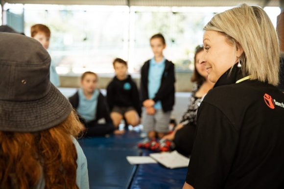 People from Save the Children speaking to school students